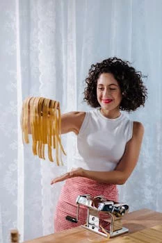 female chef pasta kitchen smiling